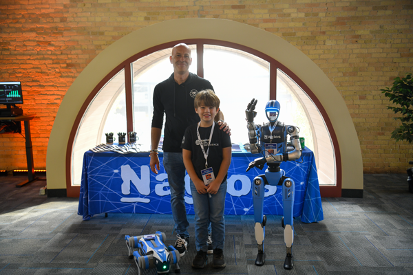 Ethan and Ian standing next to the Nagios robots.
